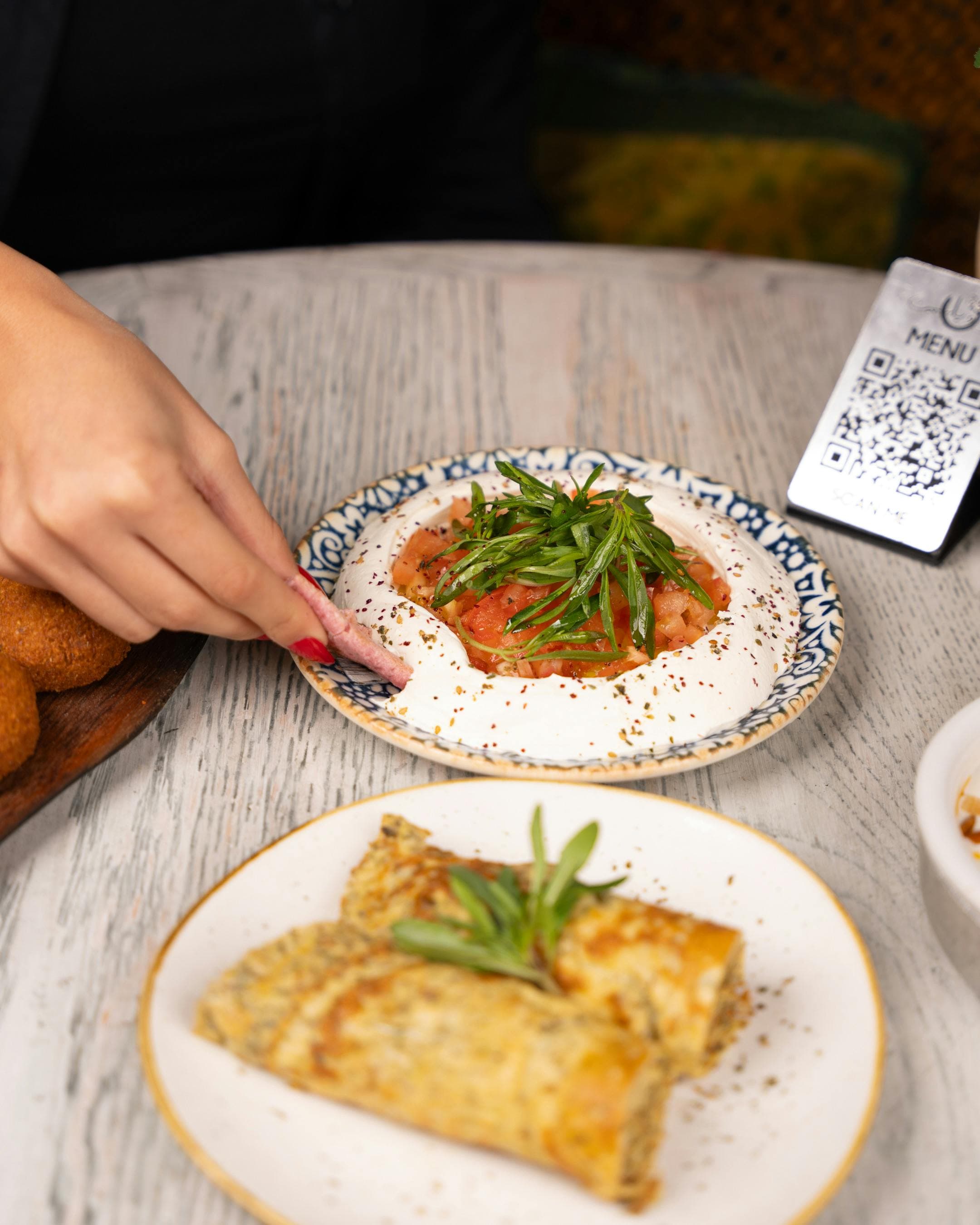 Table with food and QR code stand for ordering