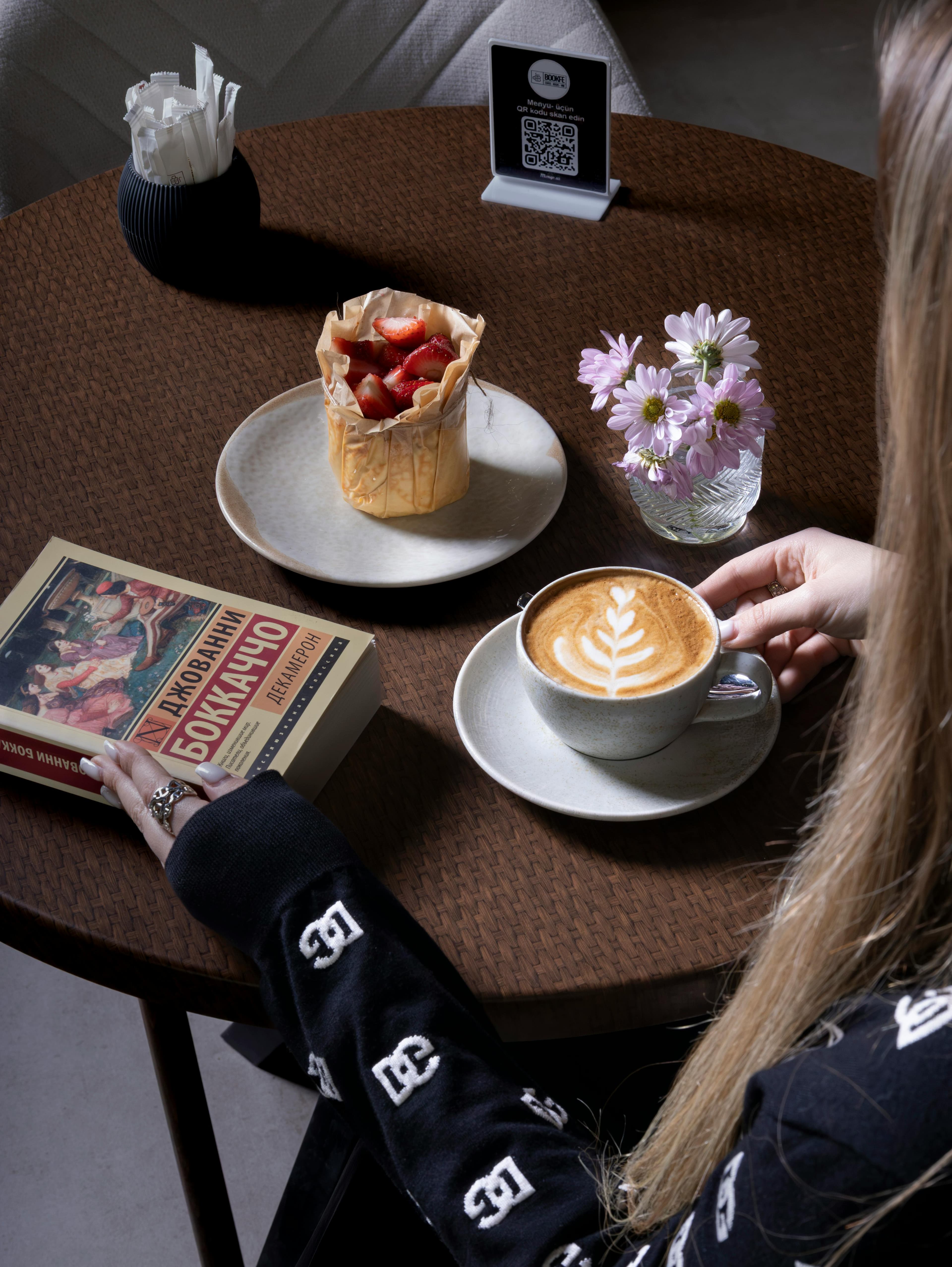 Guest enjoying coffee at an outdoor cafe table